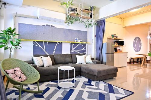 a living room with a couch and a table at Blue Theatre Near Nimmanhaemin Road and Old City in Chiang Mai