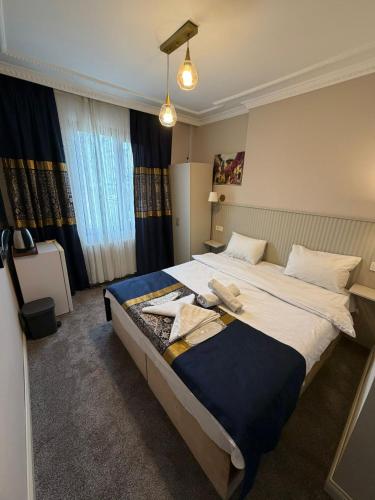 a bedroom with a large bed with towels on it at Liora Old City in Istanbul