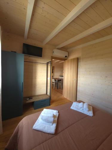 a bedroom with a bed with towels on it at Agriturismo Le Rondini Di San Bartolo in San Vincenzo