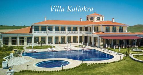 a large building with a swimming pool in front of it at Complex Villas Kaliakra & Gradina in Bŭlgarevo