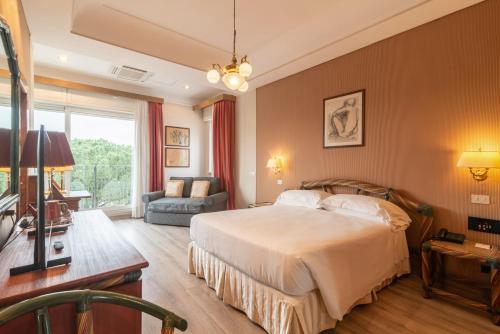 a bedroom with a bed and a desk and a couch at Best Western Hotel Rivoli in Rome