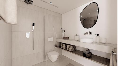 a bathroom with a toilet and a mirror at Lakeside Studios Konstanz in Konstanz
