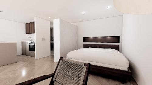 a bedroom with a bed and a chair in it at Lakeside Studios Konstanz in Konstanz