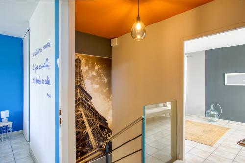 a hallway with a wall mural of the eiffel tower at Superbe Villa, 4 chambres, parking, garage et piscine in Genas