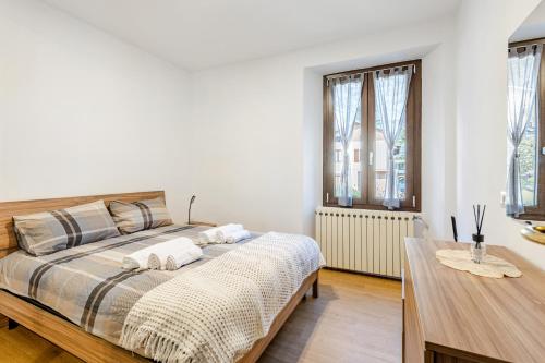 a bedroom with a bed with two towels on it at The Nest Between Lake Como e Bellagio in Castelmarte