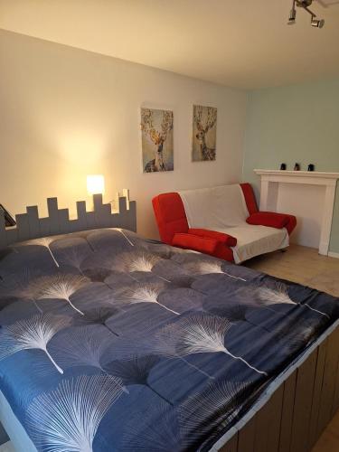 a bedroom with a large bed and a couch at Cozy countryside apartment in Moriville