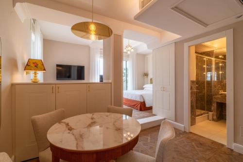 a living room with a table and a bedroom at Best Western Hotel Rivoli in Rome