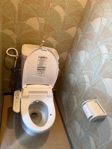 a toilet in a bathroom with a wall at 亀井町Stay501 in Takamatsu