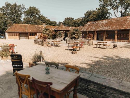 a patio with a table and chairs in front of a building at Kingston Country Courtyard in Kingston