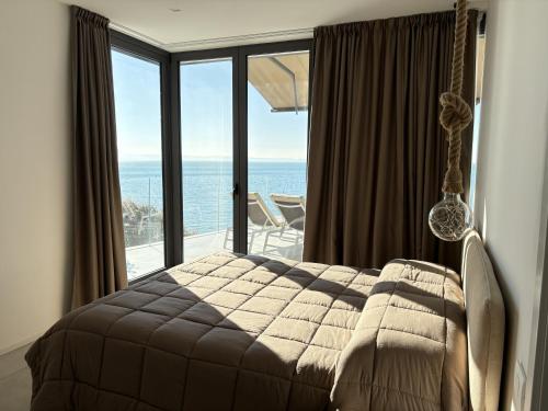 a bedroom with a swinging bed with a view of the ocean at Seaside Escape in Trieste