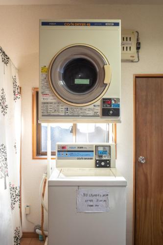 a microwave sitting on top of a refrigerator at Oyajino Umi in Naoshima
