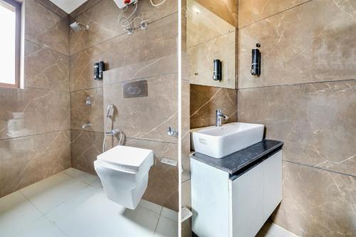 a bathroom with a toilet and a sink and a shower at Collection O Mall Road Nainital Formerly Urban Bliss in Nainital