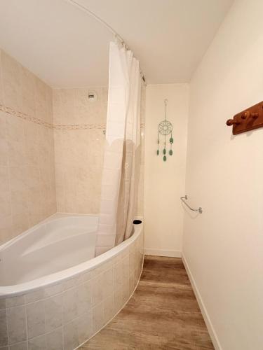 a bathroom with a tub and a shower at Birdie H N21 ST2 in Giez