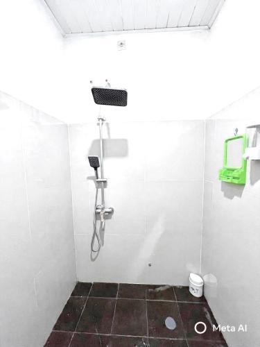 a bathroom with a shower in a white wall at Ibiza house pangandaran in Pangandaran