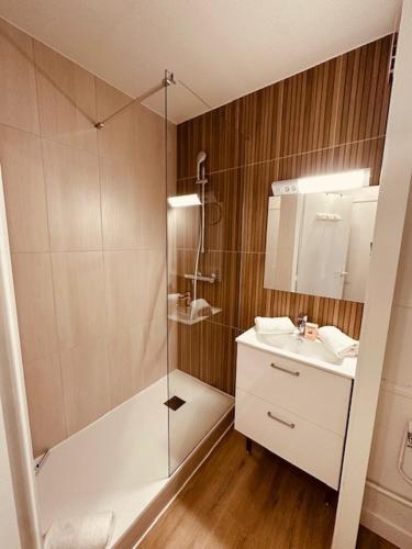 a bathroom with a shower and a sink at Sphinx Résidences - Tempologis Mémorial in Caen