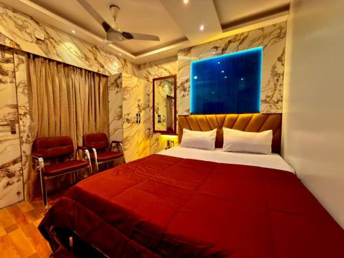 a bedroom with a large red bed in a room at Bengal Guest House in Howrah