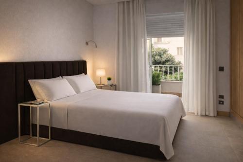 a bedroom with a large white bed and a window at Abril Plaza de España Boutique in Nerja