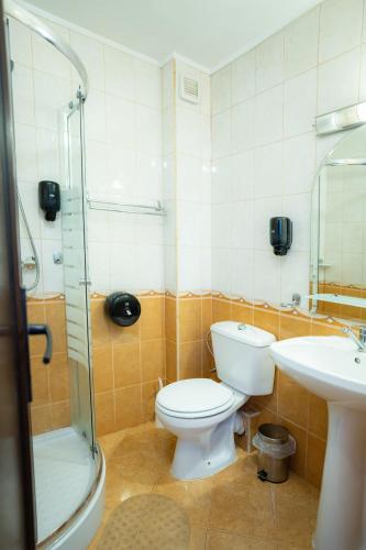 a bathroom with a toilet and a sink and a shower at Motel Delorean in Săcele