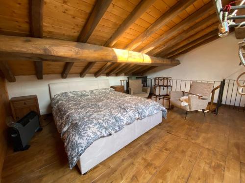 a bedroom with a bed and a surfboard on the ceiling at Sicily Private Pool House in Nature in Montargano