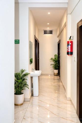 a bathroom with a sink and two potted plants at Hotel Ayodhya in Ayodhya