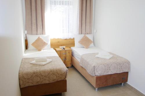 a bedroom with two beds and a window at Villa Riviera in Nedeščina