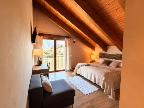 a bedroom with a bed and a large window at As Fuebas de Patricio in Vío