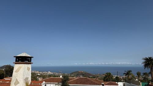a lighthouse with the ocean in the background at Holiday Feel - La Orotava in La Orotava
