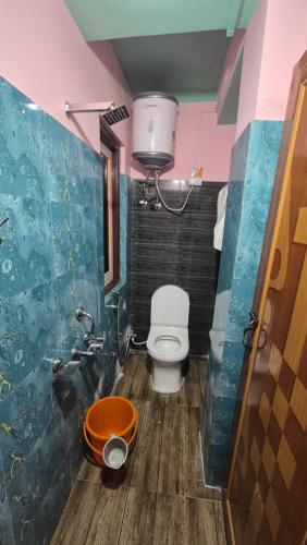 a bathroom with a toilet and a sink at Rainbow Guest House in Sonāda