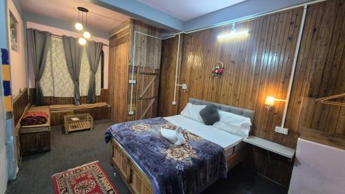 a bedroom with a large bed and a shower at Rainbow Guest House in Sonāda