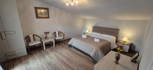 a hotel room with a bed and a table and chairs at Casa di Clara in Sulmona