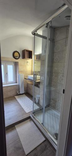 a bathroom with a shower with a glass door at Casa di Clara in Sulmona