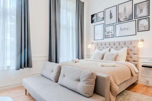 a bedroom with a large bed and a couch at Prenzlauer Berg Prestige in Berlin