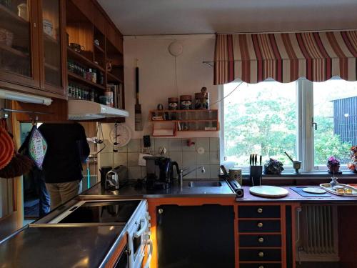 a kitchen with a sink and a stove and a window at Workers Stay - Construction Worker Göteborg in Gothenburg