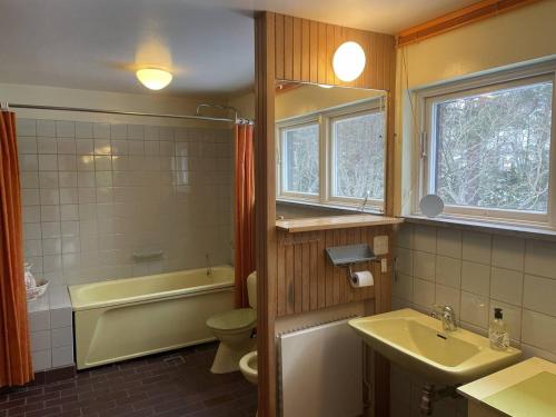 a bathroom with a sink and a tub and a toilet at Workers Stay - Construction Worker Göteborg in Gothenburg