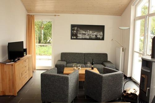 a living room with a couch and a table at Ferienhaus Grafschafter Perle in Nordhorn