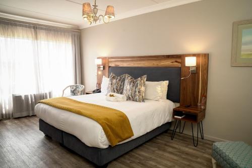 a bedroom with a large bed in a room at CedarWoods of Sandton in Sandton