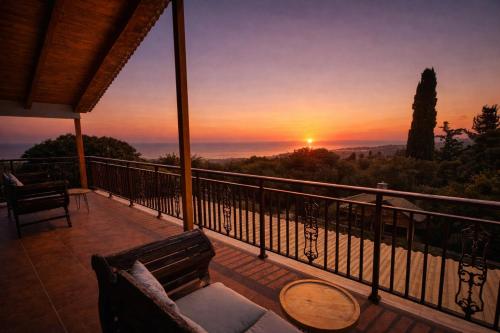 a sunset from the balcony of a house at Villa Hestia - Seaview Serenity Villa with Private Pool by Villa Mana Gers in Kypseli