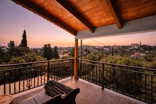 a balcony with a bench and a view of the city at Villa Hestia - Seaview Serenity Villa with Private Pool by Villa Mana Gers in Kypseli