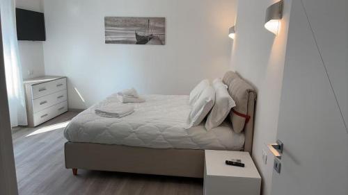 a small bedroom with a bed and a table at Tourgo Venice in Mestre