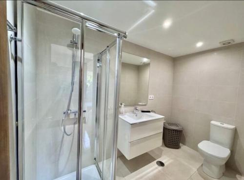 a bathroom with a shower and a toilet and a sink at Bellaluz 18-16 La Manga Club in Atamaría