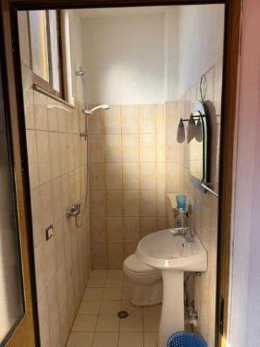 a bathroom with a toilet and a shower and a sink at Deda Apartaments in Shëngjin