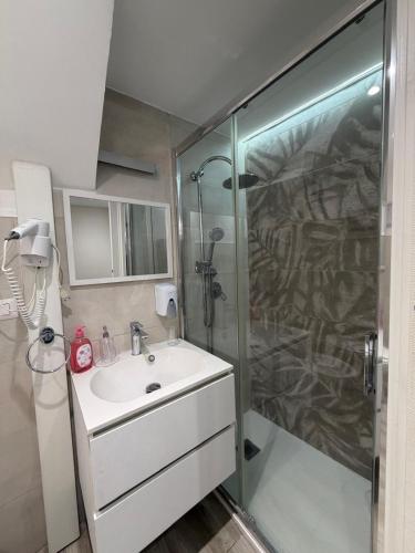 a bathroom with a shower and a sink and a shower at Spataro Home in Catania
