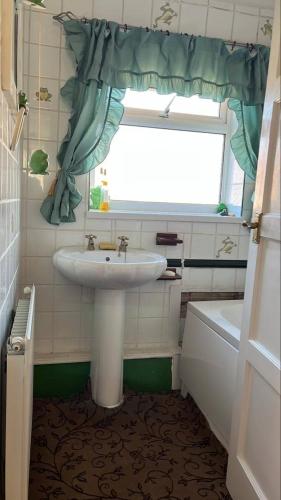 a bathroom with a sink and a window at Teesside Haven in Middlesbrough in Middlesbrough