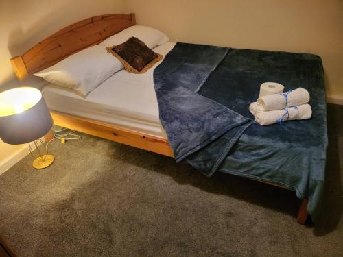 a bedroom with a bed with towels on it at Teesside Haven in Middlesbrough in Middlesbrough