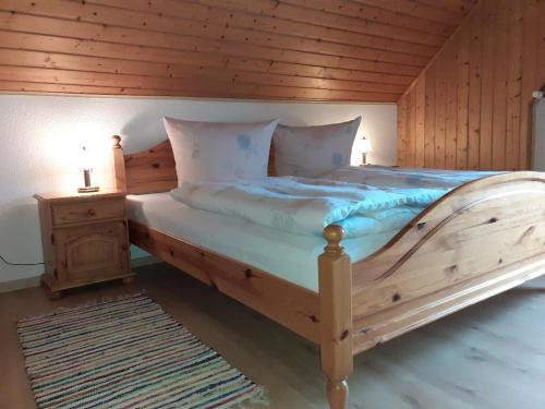 a bedroom with a large bed with a wooden ceiling at Mattheishof in Grafenau