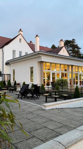 a building with a lot of benches in front of it at Lochgreen House Hotel & Spa in Troon
