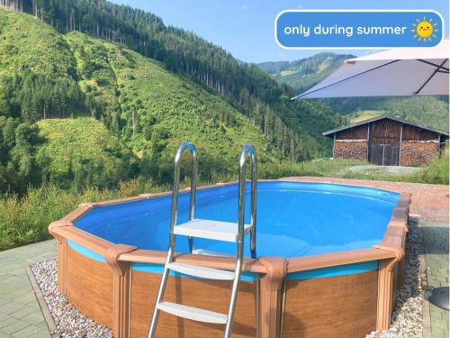 a chair sitting next to a swimming pool at Hinterbichlhof - Apartments in Viehhofen