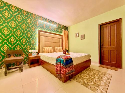 a bedroom with a bed and a chair at The Bay Leaf Resort in Shimla