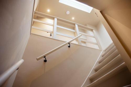 a stairway with a hand rail in a room at Studio Strandkasteel, Free parking in Zandvoort
