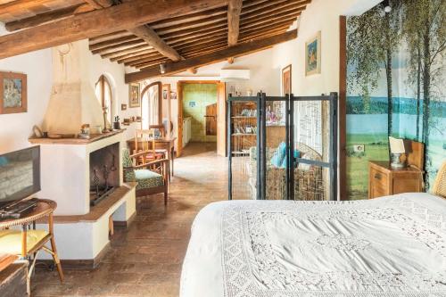 a bedroom with a bed and a fireplace at Sunset and lake in Bolsena